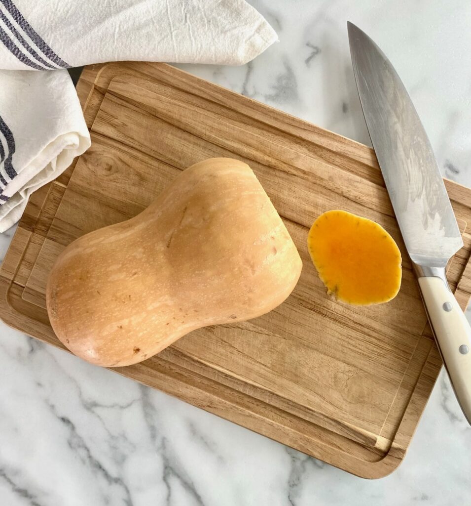 butternut squash and knife on cutting board