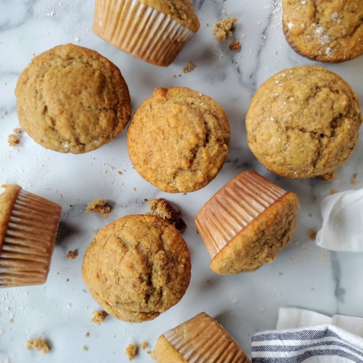 healthy banana muffins with crumbs on a counter