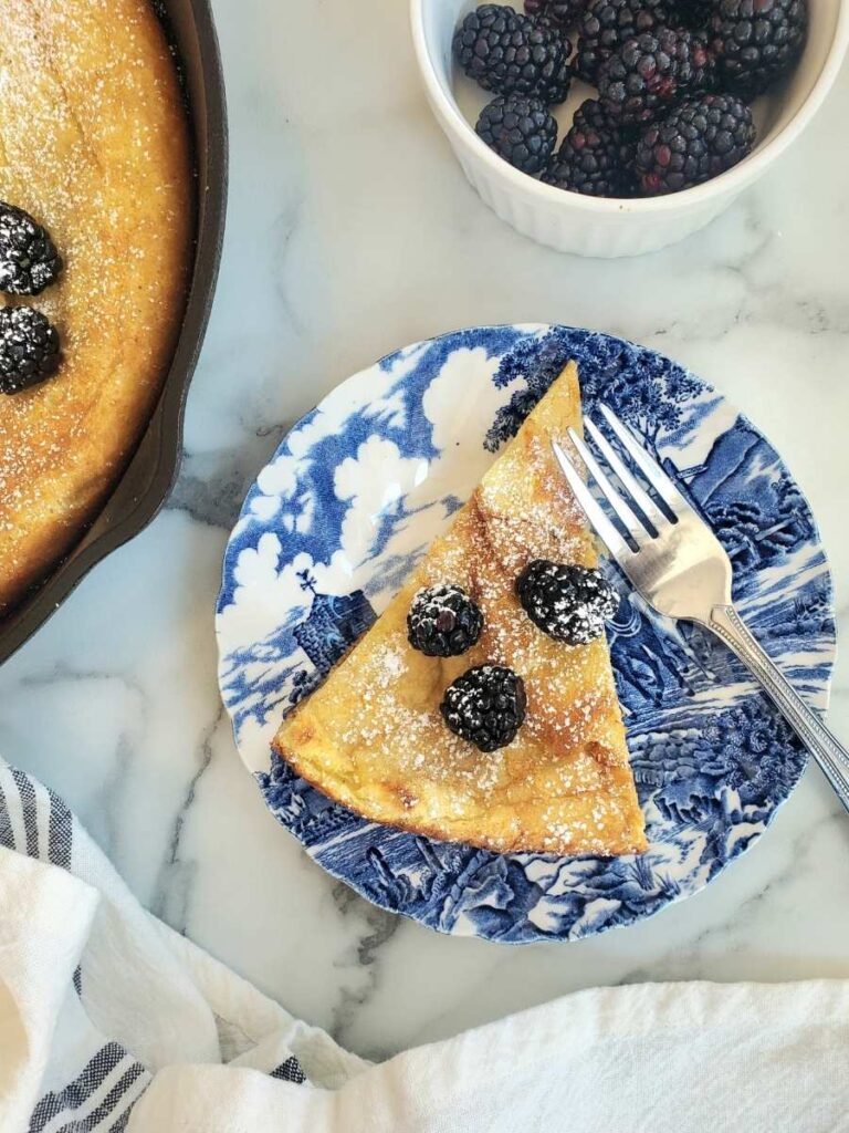 slice of sourdough german pancake with blackberries on a plate