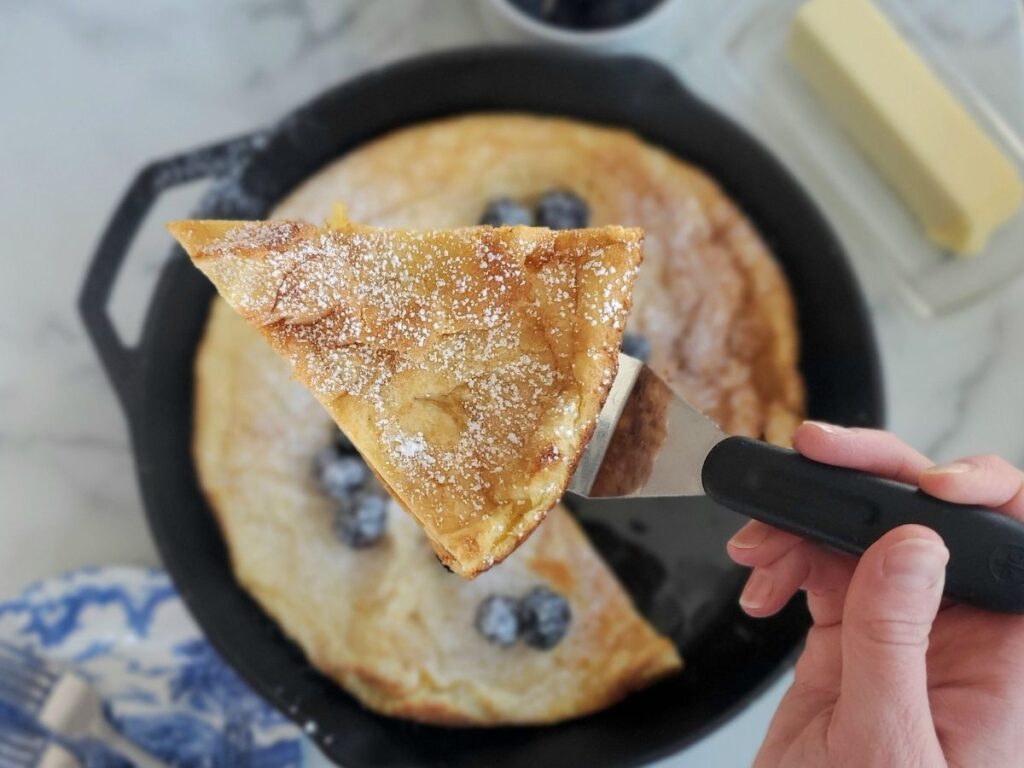 slice of sourdough dutch baby on a serving utensil
