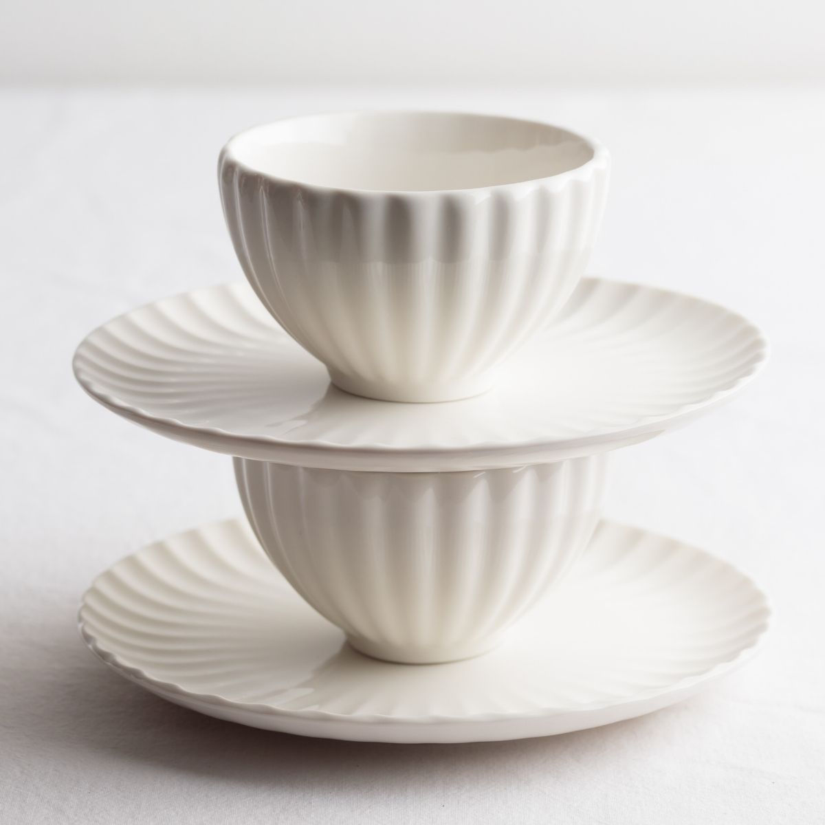 WHITE TEACUPS STACKED