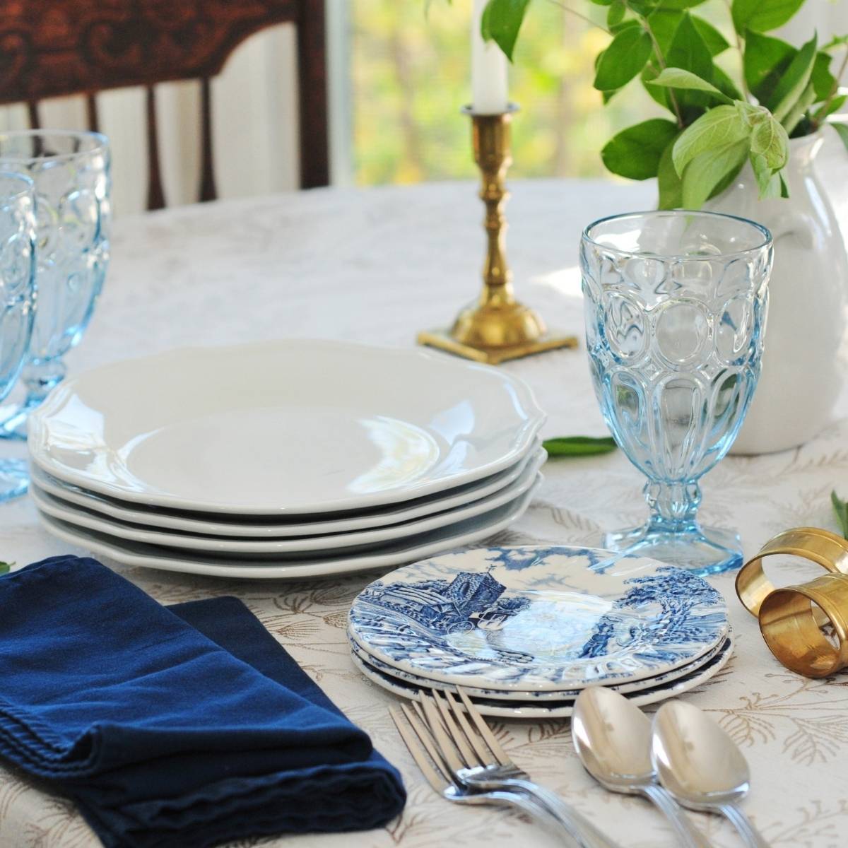 blue and white dishes with goblets on a table