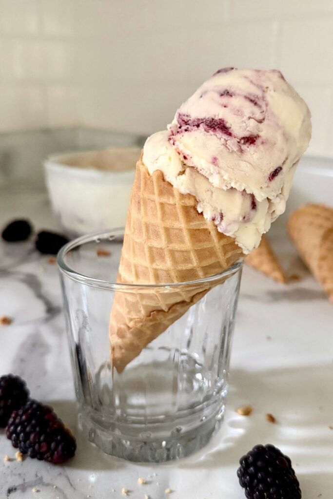 blackberry cheesecake ice cream in a cone