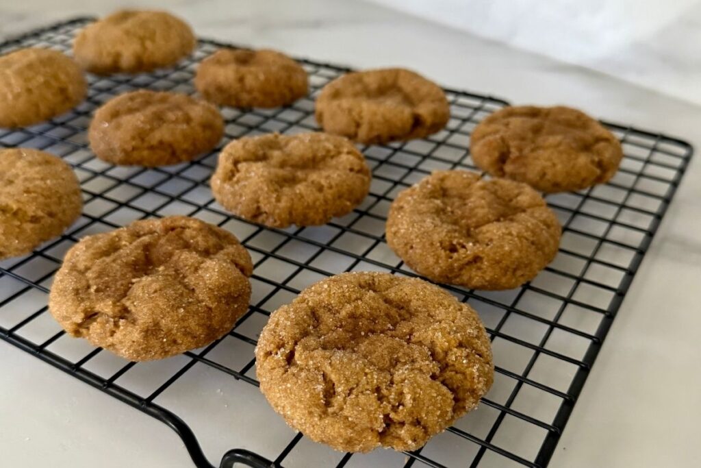 sourdough pumpkin snickerdoodle cookies on a wire rack