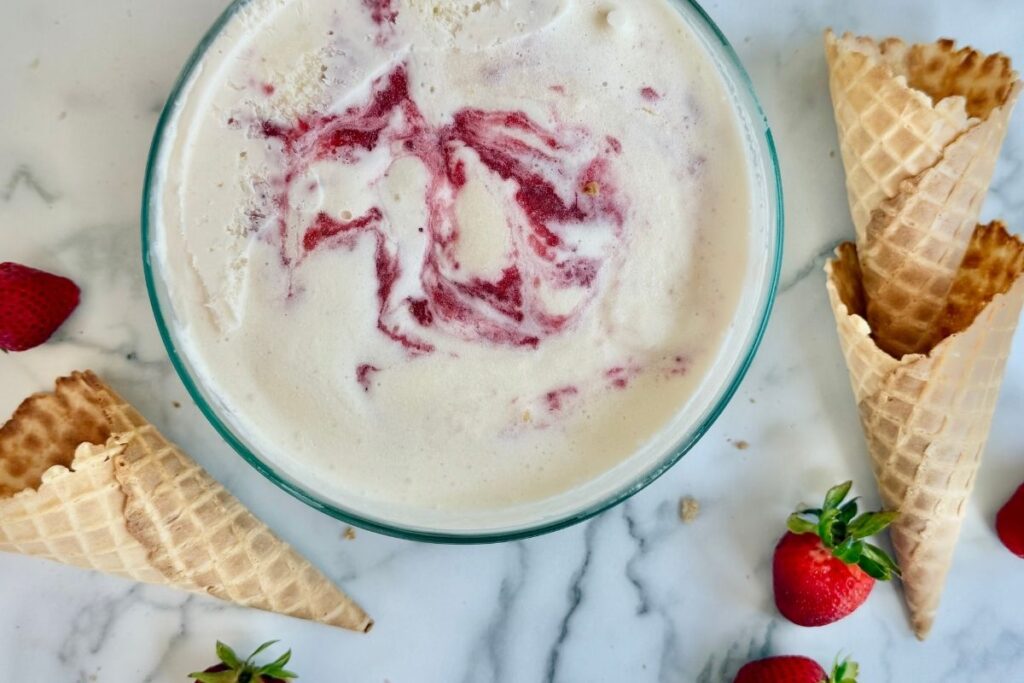 strawberry cheesecake ice cream with waffe cones and strawberries