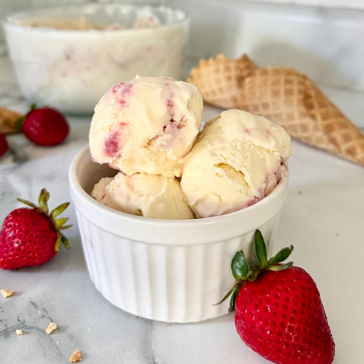strawberry cheesecake raw milk ice cream in a ramekin