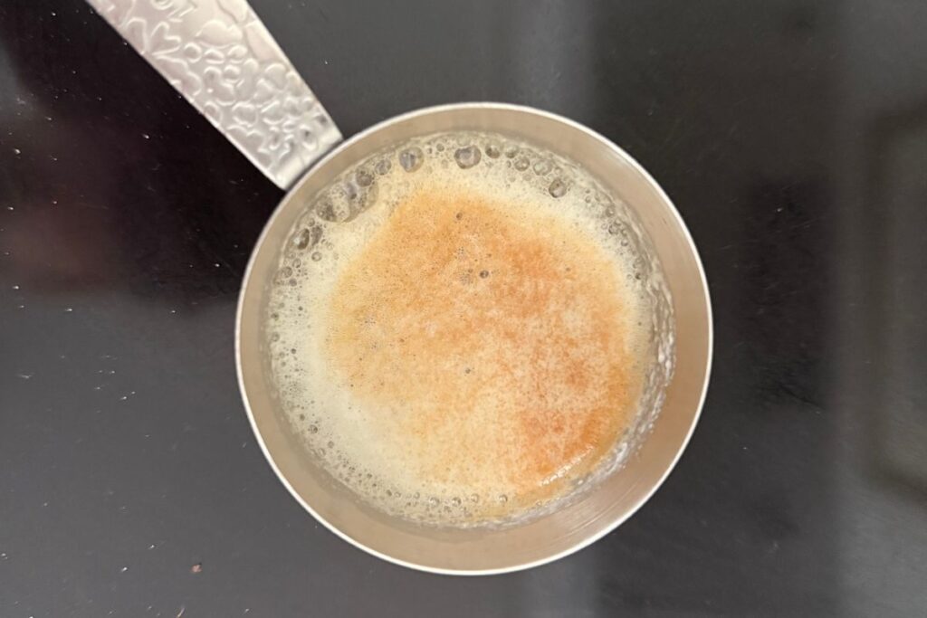 browned butter in a measuring cup