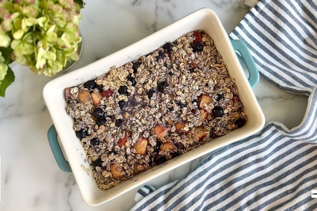 brown butter peach blueberry baked oatmeal in a baking dish