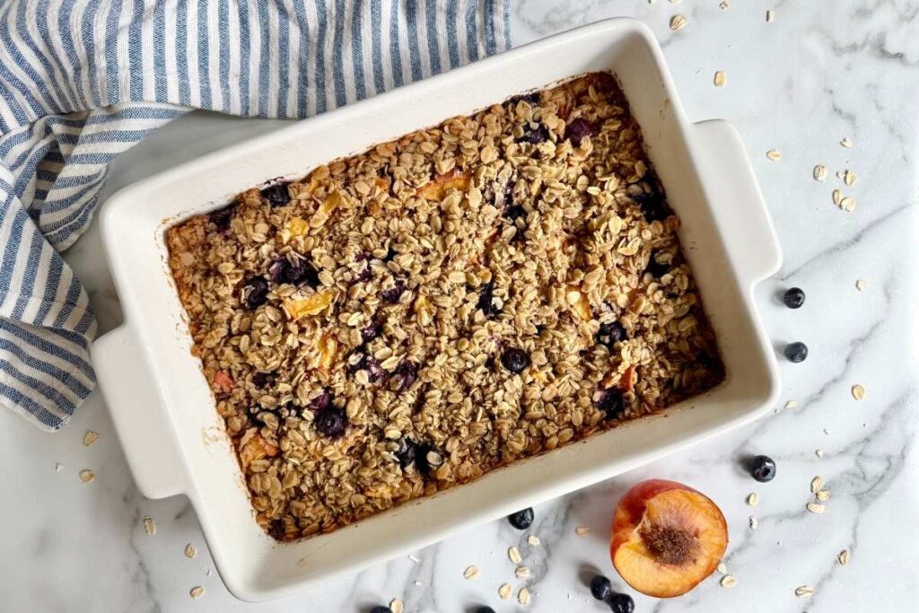 brown butter peach blueberry baked oatmeal in a baking dish