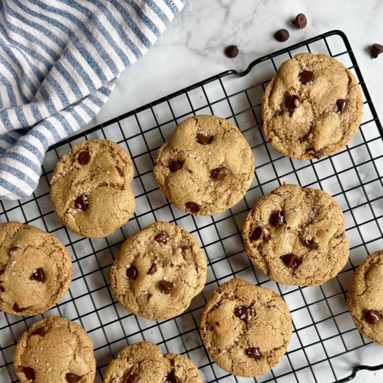 chewy brown butter chocolate chip cookies with sea salt on a cooling rack