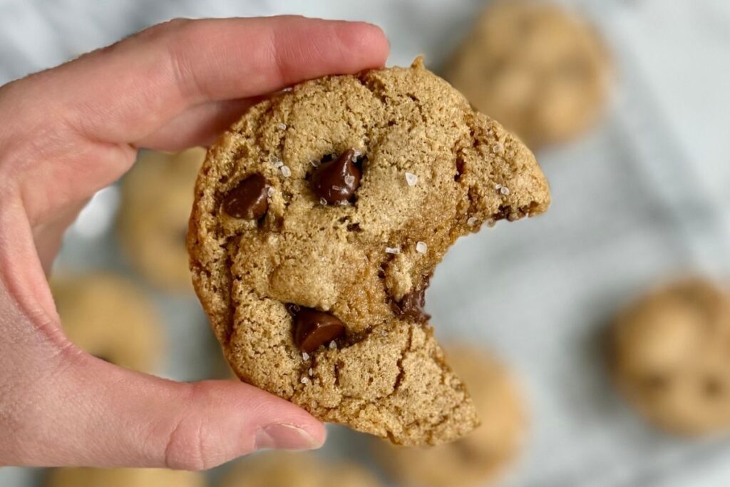 chewy brown butter chocolate chip cookies with sea salt on a cooling rack