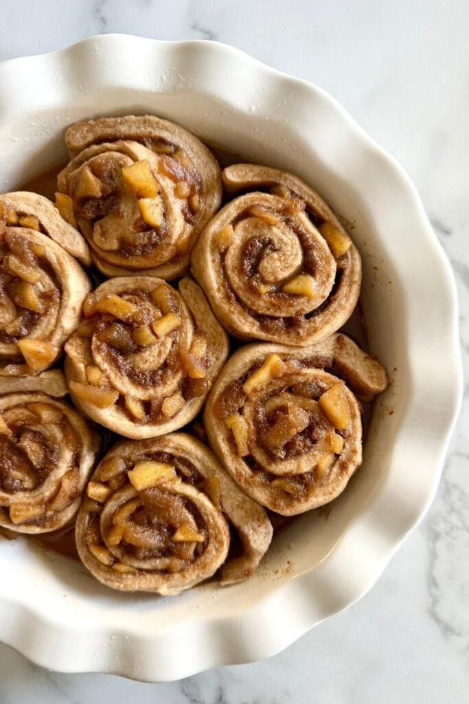 fresh milled apple pie sourdough cinnamon rolls in a pie plate