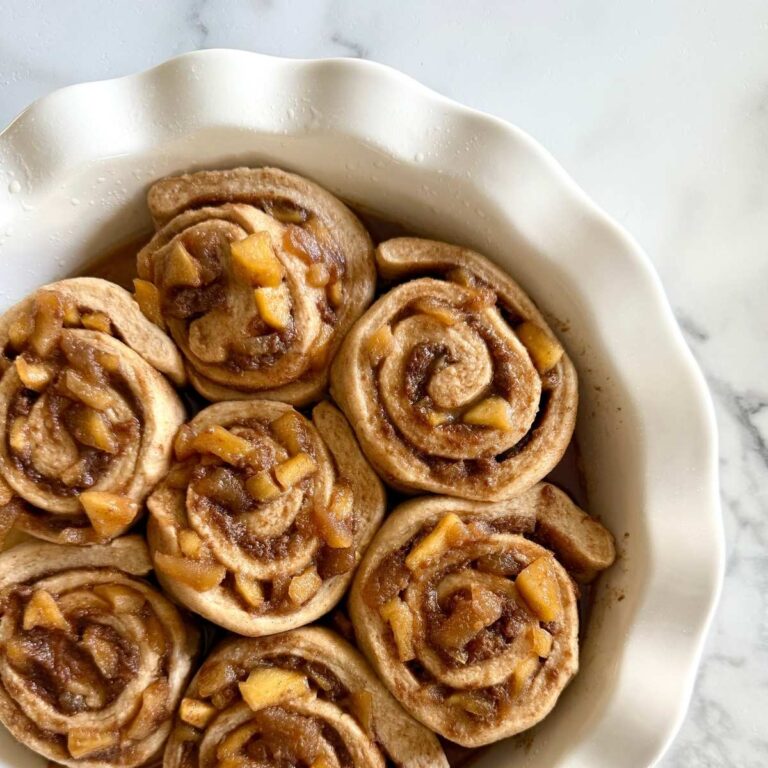 fresh milled sourdough apple pie cinnamon rolls in a pie plate