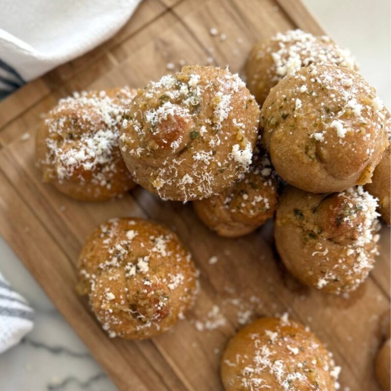 fresh milled sourdough garlic knots on a wood cutting board