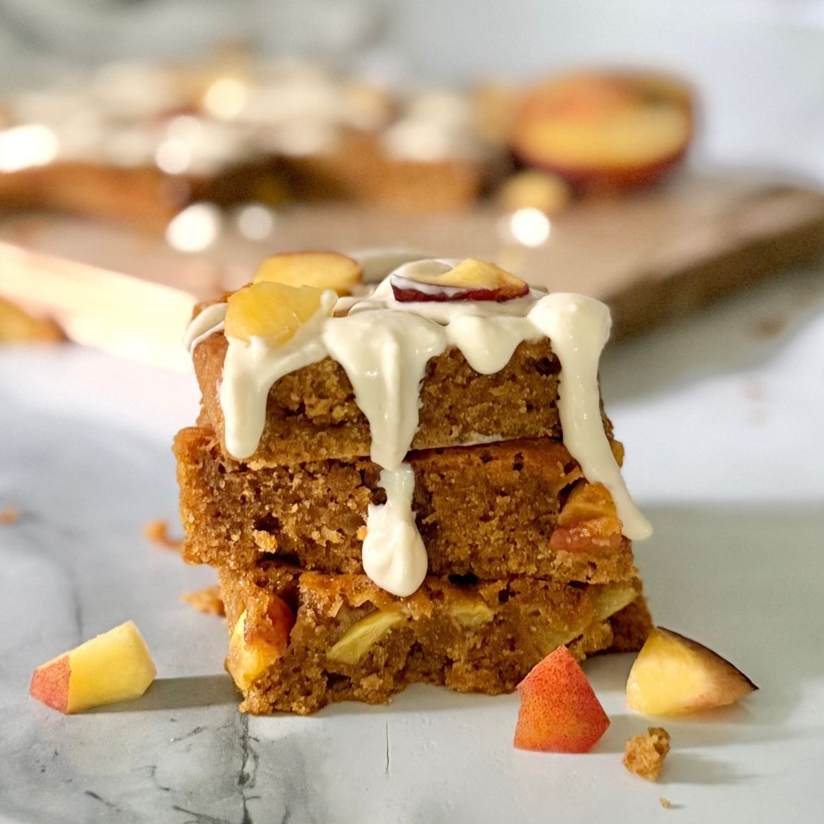 peach brown butter einkorn blondie with cream cheese icing dripping
